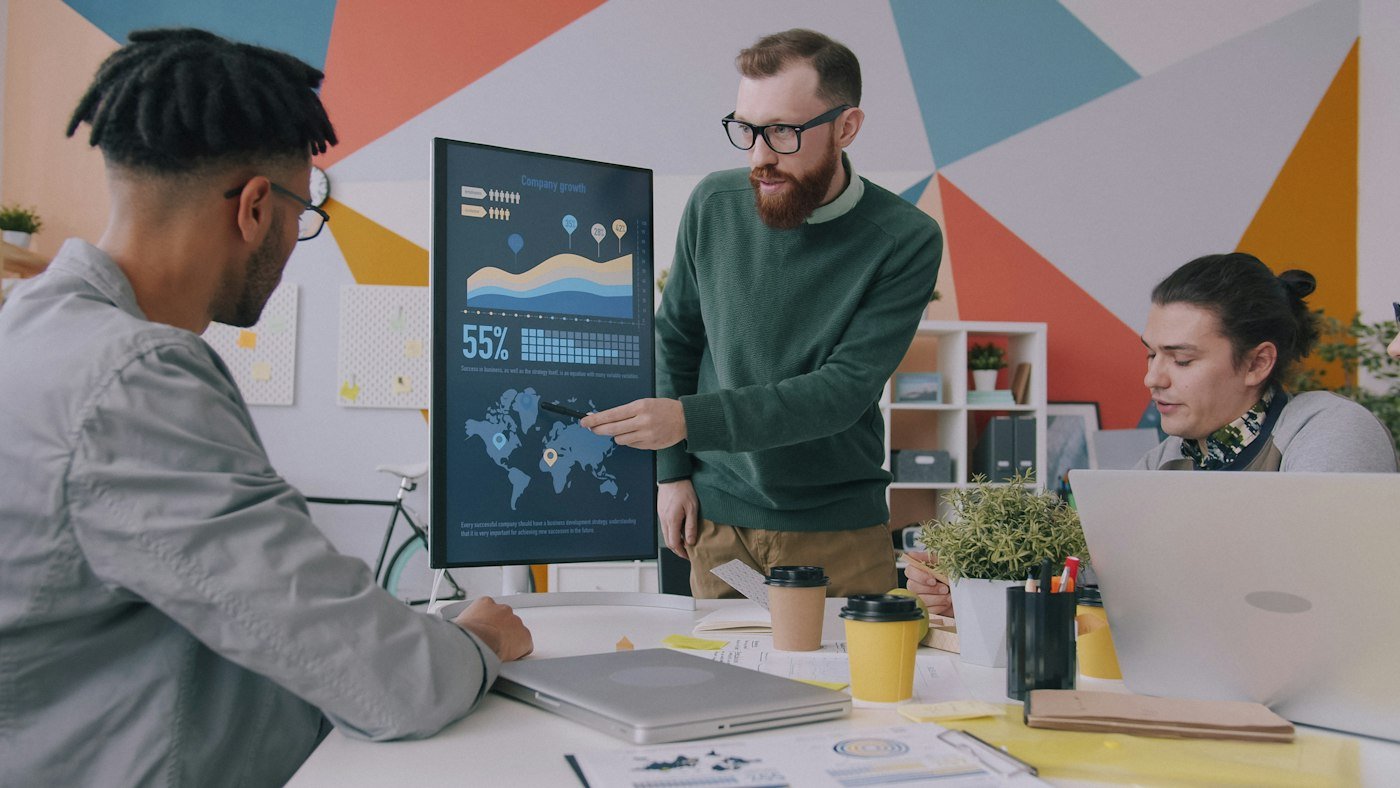 Business team reviewing a CRM analytics dashboard on a screen