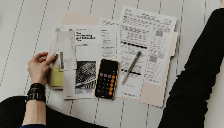 Finance professional reviewing documents and receipts with a calculator