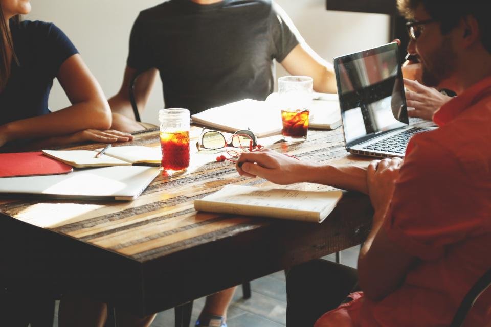 Project team holding a requirements workshop around a meeting table