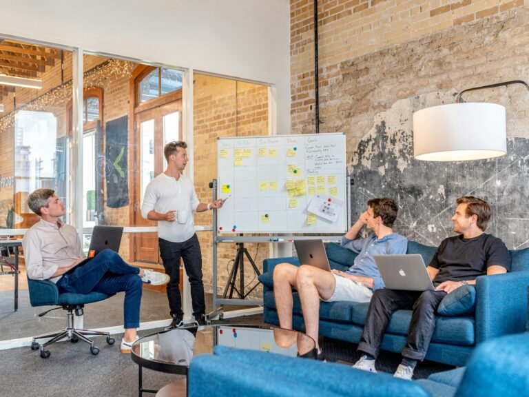 Project manager walking a delivery team through a plan on a whiteboard