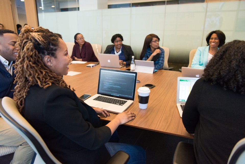 Development team collaborating on laptops around a meeting table