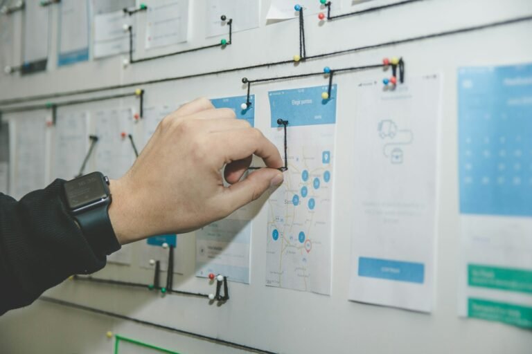 Person mapping a process flow on a wall board