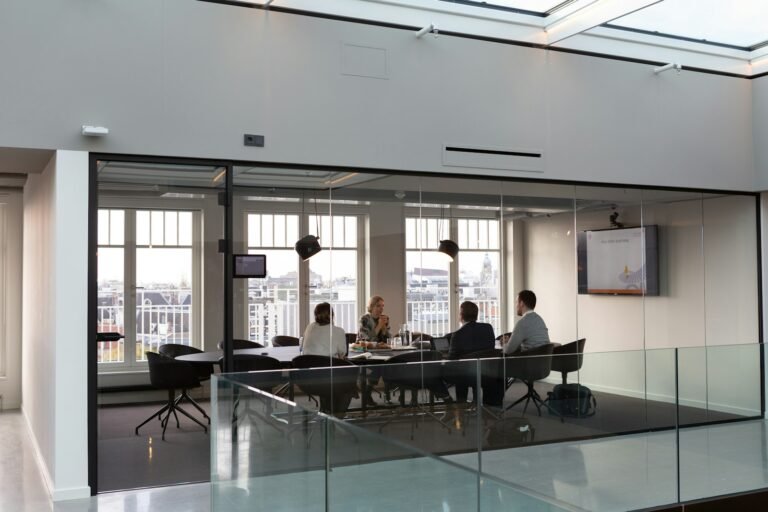 Team meeting in a glass-walled office conference room